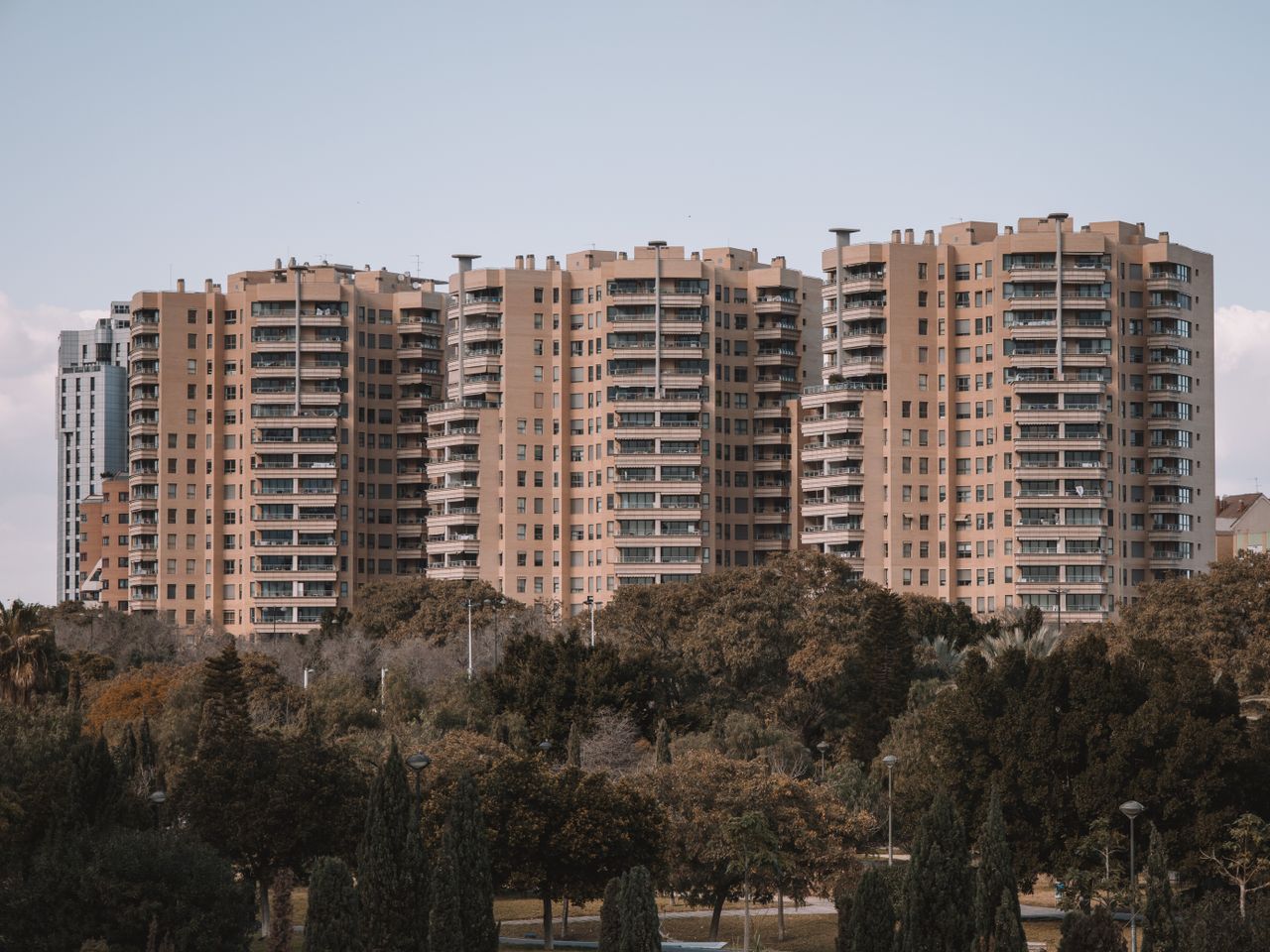 Mastering the First Impression: Your intriguing post title goes here Seventeen-story apartment buildings in Valencia, Spain, with surrounding greenery under a clear sky.